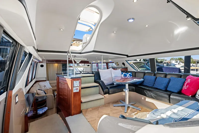 Slide: The Image of Luxurious interior of a 1999 Carver 53 Voyager yacht with plush seating and modern design. - 12