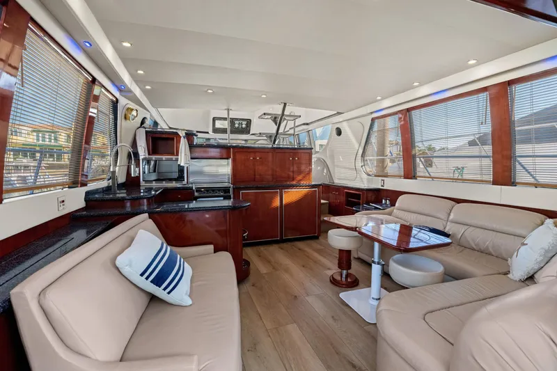 Slide: The Image of Luxurious interior of 1999 Carver 53 Voyager yacht with modern kitchen and seating area. - 4