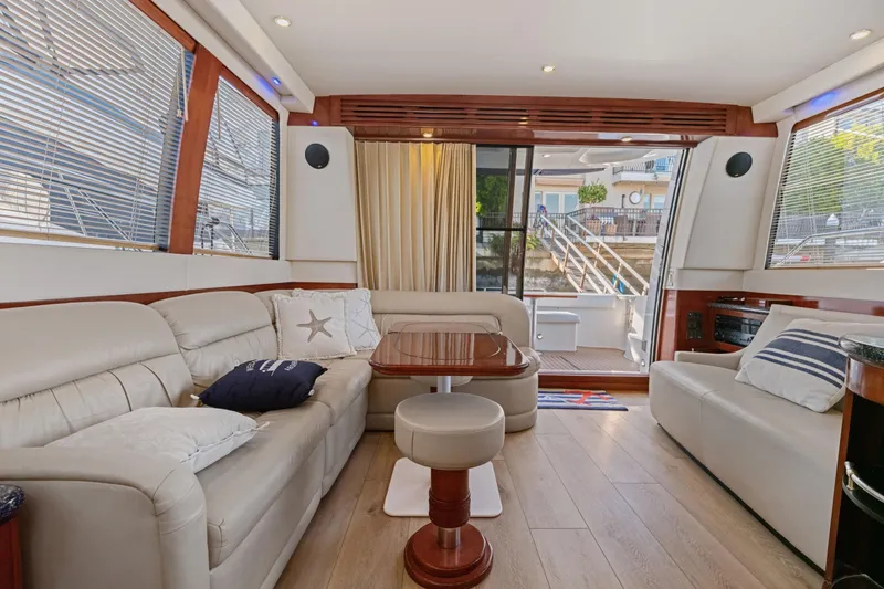Slide: The Image of Luxurious interior of 1999 Carver 53 Voyager yacht with plush seating and elegant decor. - 5