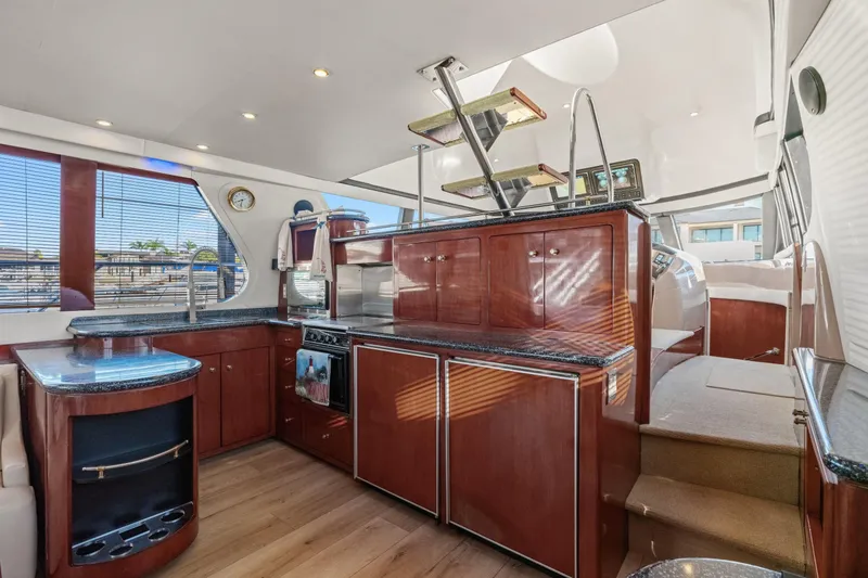 Slide: The Image of Interior of 1999 Carver 53 Voyager yacht with modern kitchen and wooden cabinetry. - 7