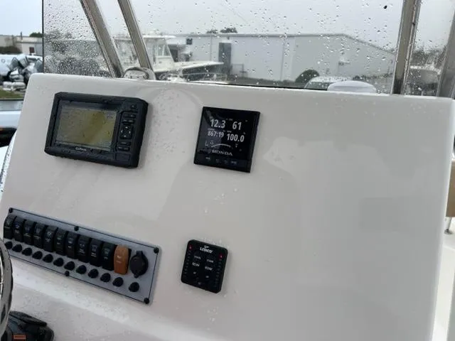 Slide: The Image of Control panel of a 2020 Key West 239 FS boat with navigation and engine displays. - 14