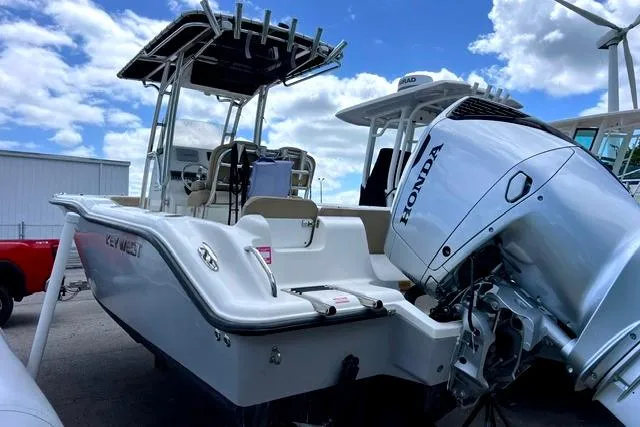 Slide: The Image of 2020 Key West 239 FS boat with Honda outboard motor, docked under a blue sky. - 3