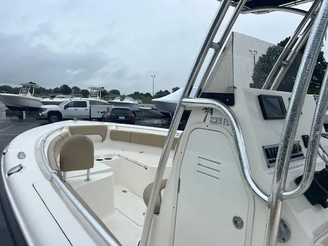 Slide: The Image of 2020 Key West 239 FS boat in a marina with other boats and vehicles. - 9