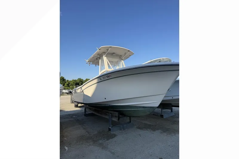 Slide: The Image of 2011 Grady-White Fisherman 230 boat on dry dock under clear blue sky. - 1