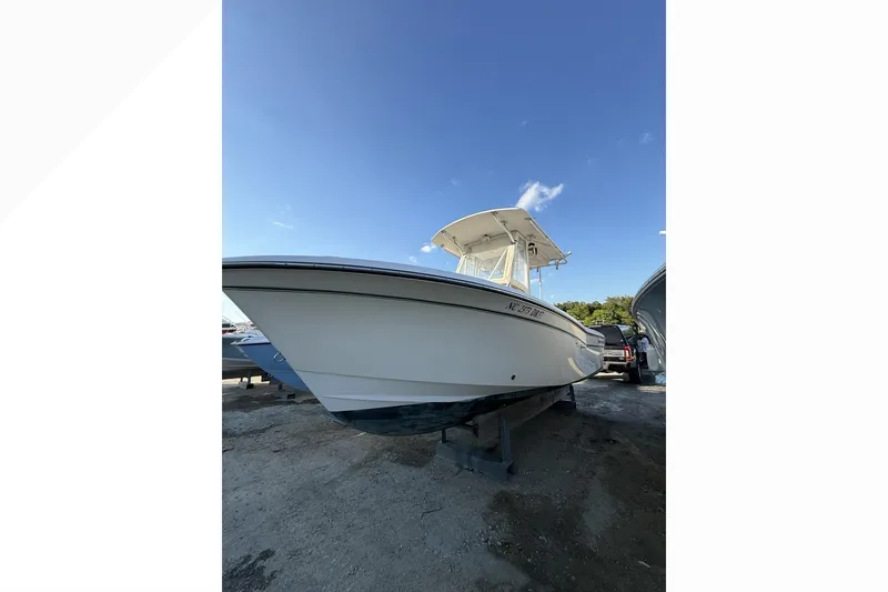 Slide: The Image of 2011 Grady-White Fisherman 230 boat on display under clear blue sky. - 2