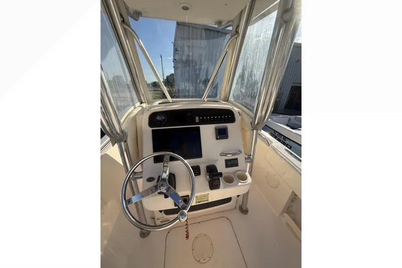 Slide: The Image of 2011 Grady-White Fisherman 230 boat console with steering wheel and navigation controls. - 5