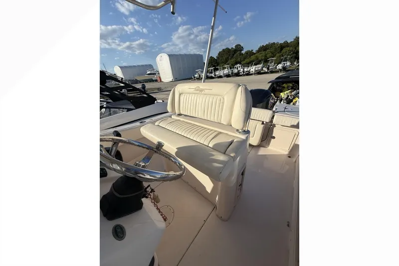Slide: The Image of 2011 Grady-White Fisherman 230 boat interior with steering wheel and seating. - 9