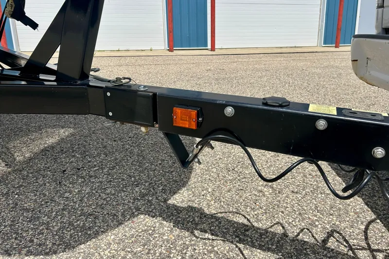 Slide: The Image of Trailer hitch of a 2021 Scarab 195 ID on asphalt, near storage units. - 16