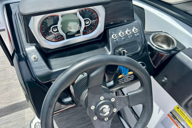 Slide: The Image of Dashboard of a 2021 Scarab 195 ID boat with steering wheel and controls. - 19