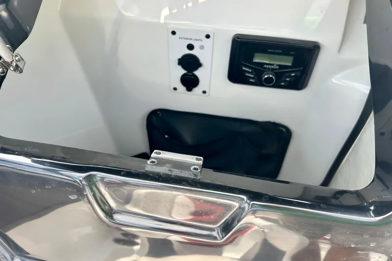Slide: The Image of Interior view of a 2021 Scarab 195 ID boat featuring control panel and stereo system. - 21