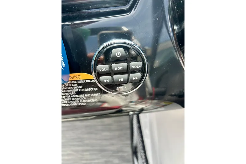 Slide: The Image of Control panel of a 2021 Scarab 195 ID boat with volume and mode buttons. - 27