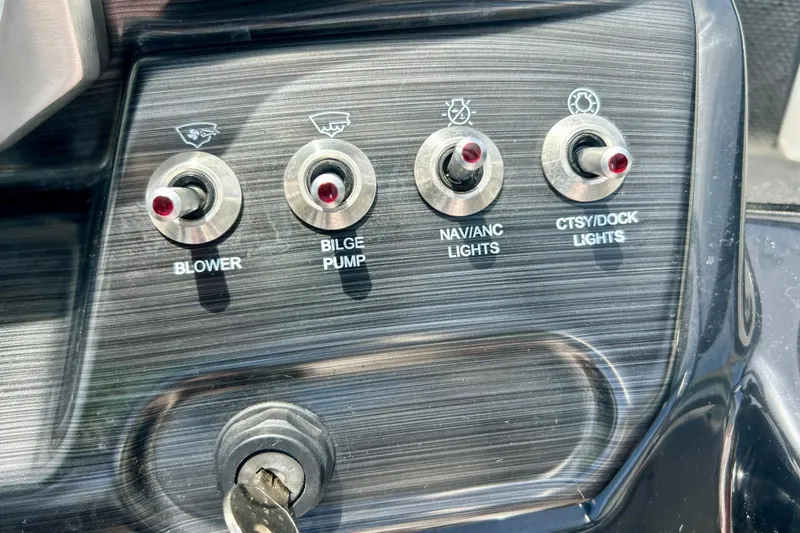 Slide: The Image of Control panel of a 2021 Scarab 195 ID boat with switches for blower, bilge pump, and lights. - 28