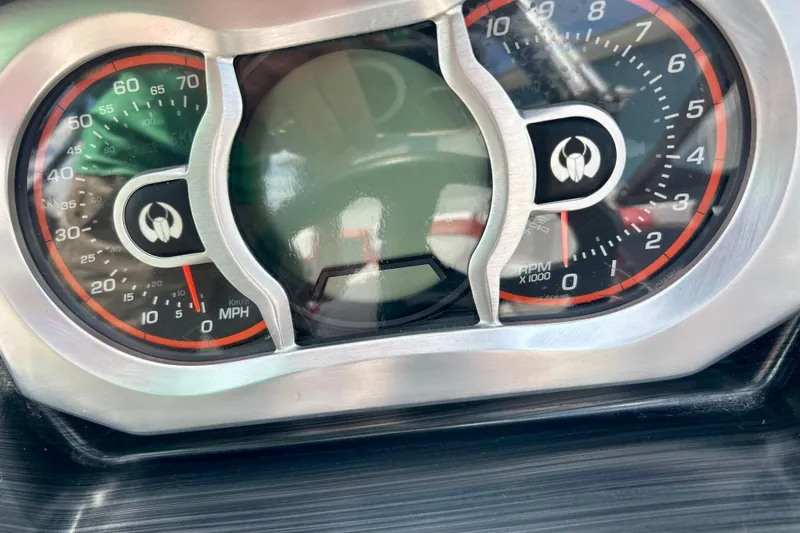 Slide: The Image of Dashboard of a 2021 Scarab 195 ID boat, showing speedometer and tachometer. - 29