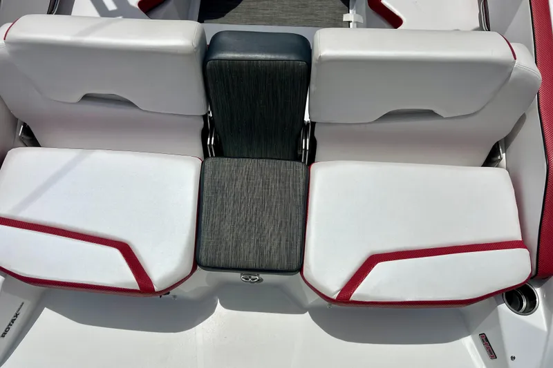 Slide: The Image of 2021 Scarab 195 ID boat interior with white and red seating, featuring a central black cushion. - 38