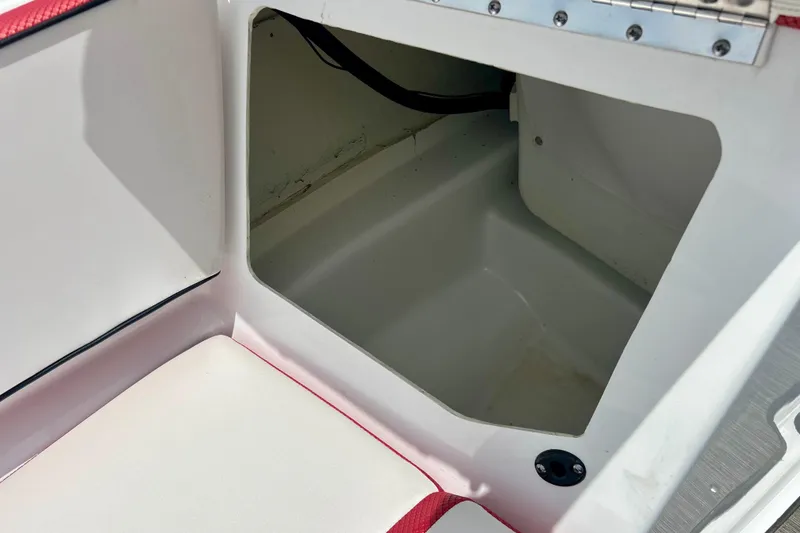 Slide: The Image of Storage compartment in 2021 Scarab 195 ID boat, featuring white and red interior. - 50