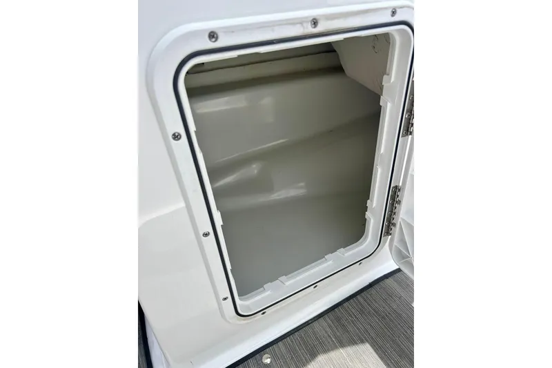 Slide: The Image of Open storage compartment on a 2021 Scarab 195 ID boat, showcasing interior space. - 52