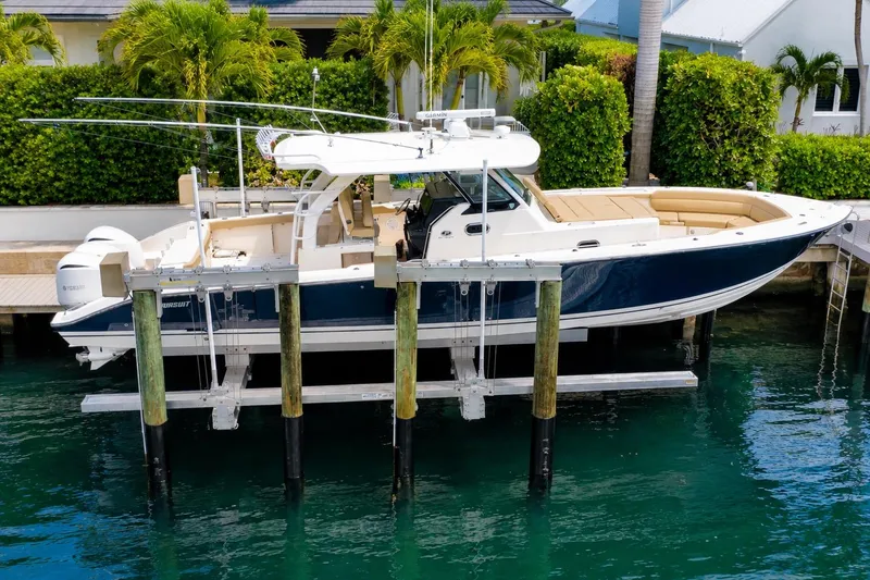 Slide: The Image of 2018 Pursuit S 408 Sport boat docked, featuring sleek design and luxurious seating. - 2