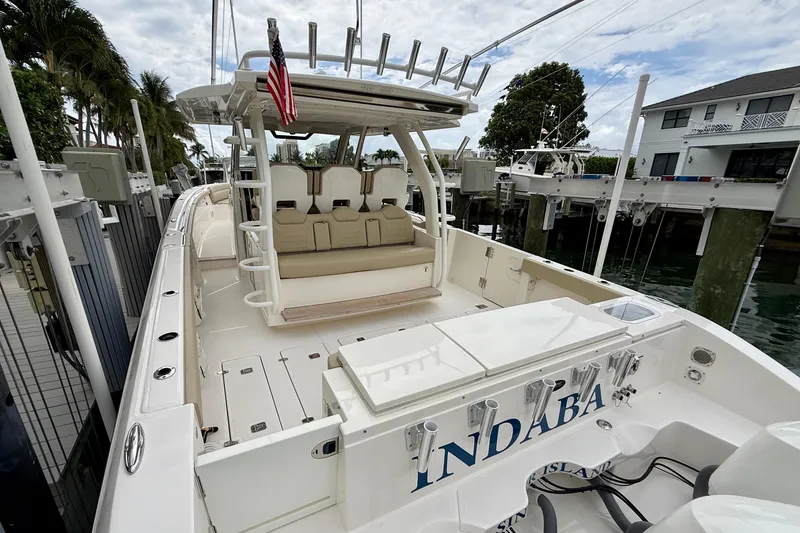 Slide: The Image of 2018 Pursuit S 408 Sport boat docked, featuring spacious seating and sleek design. - 24