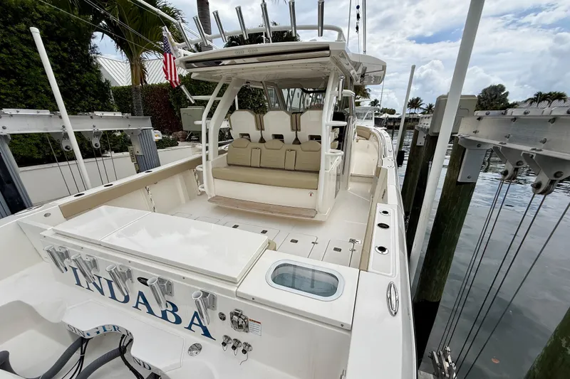 Slide: The Image of 2018 Pursuit S 408 Sport boat docked, featuring spacious seating and fishing amenities. - 25
