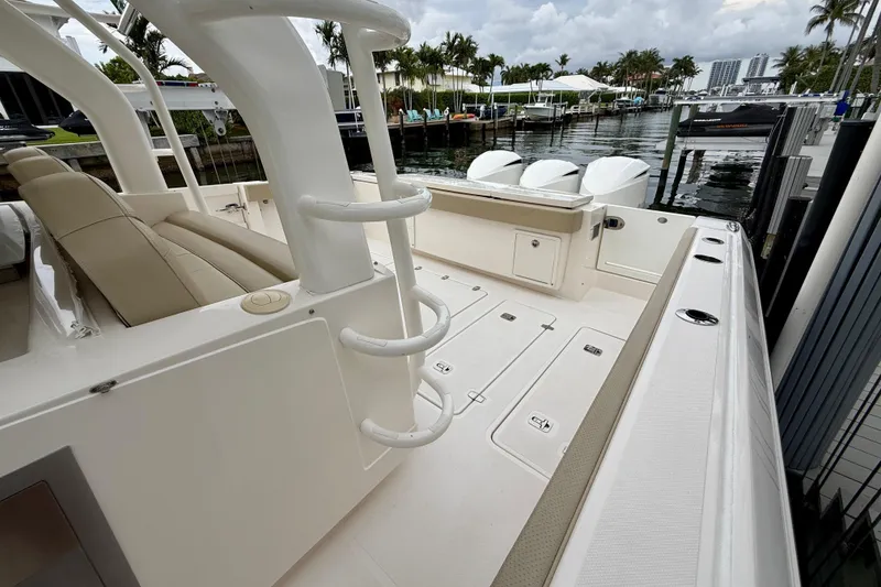 Slide: The Image of 2018 Pursuit S 408 Sport boat interior with seating and dockside view. - 28
