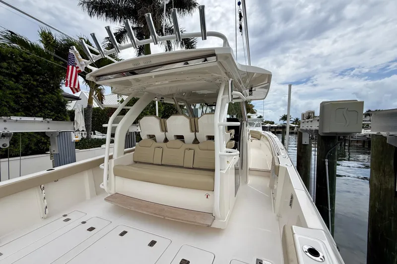 Slide: The Image of 2018 Pursuit S 408 Sport boat docked, featuring spacious seating and sleek design. - 30