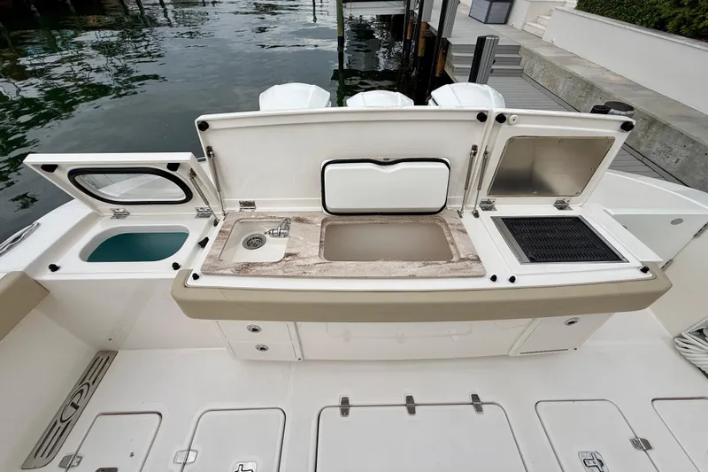 Slide: The Image of 2018 Pursuit S 408 Sport boat with open deck storage and sink area. - 33