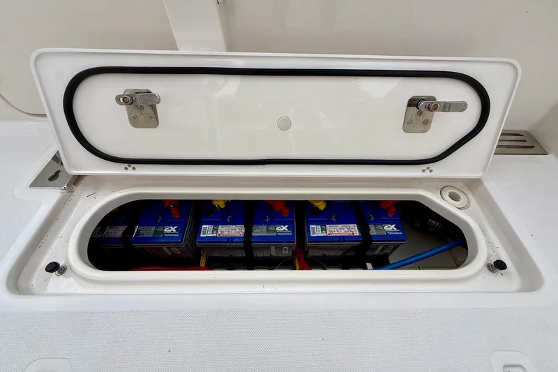 Slide: The Image of Battery compartment of a 2018 Pursuit S 408 Sport boat, showcasing multiple batteries. - 34