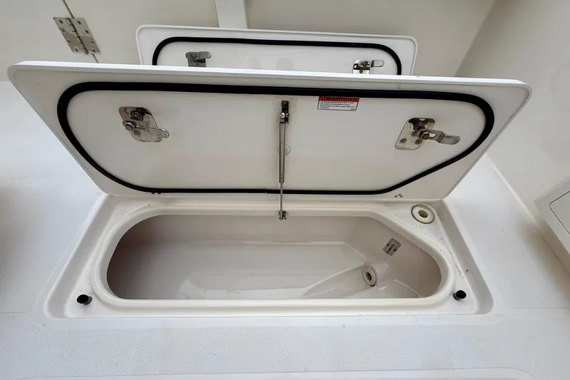 Slide: The Image of Open storage compartment on 2018 Pursuit S 408 Sport boat. - 35