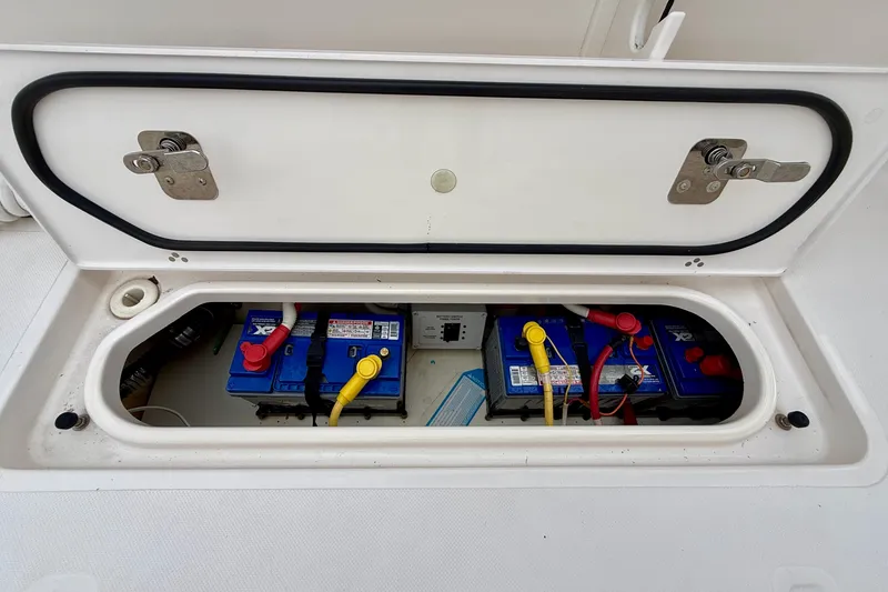 Slide: The Image of Battery compartment of 2018 Pursuit S 408 Sport boat, showing multiple blue batteries. - 36