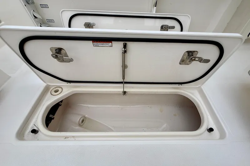 Slide: The Image of Open storage compartment on a 2018 Pursuit S 408 Sport boat. - 37