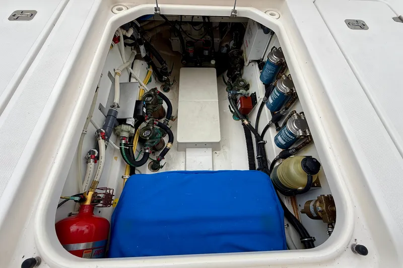 Slide: The Image of Engine compartment of a 2018 Pursuit S 408 Sport boat, showcasing mechanical components and systems. - 39