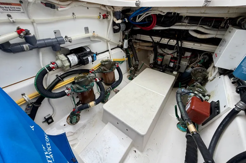 Slide: The Image of Engine room of a 2018 Pursuit S 408 Sport boat, showcasing complex wiring and components. - 40