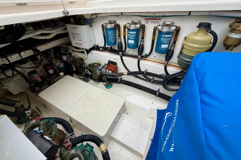 Slide: The Image of Engine compartment of a 2018 Pursuit S 408 Sport boat, showcasing Yamaha fuel filters and wiring. - 41