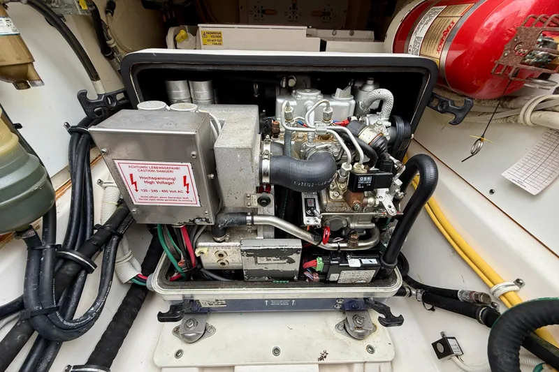 Slide: The Image of Engine compartment of a 2018 Pursuit S 408 Sport boat, featuring high voltage warning. - 42