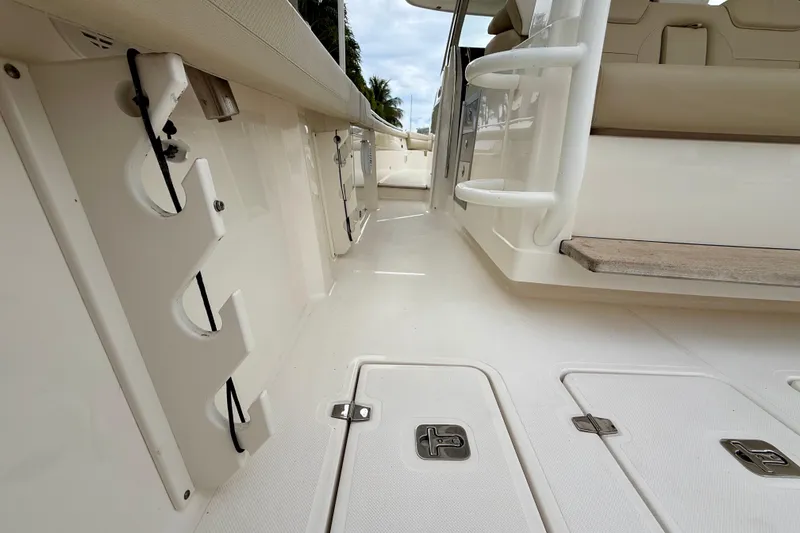 Slide: The Image of 2018 Pursuit S 408 Sport boat interior with rod holders and seating area. - 48