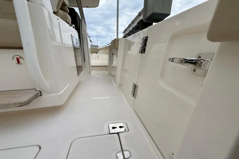 Slide: The Image of 2018 Pursuit S 408 Sport boat interior, featuring sleek white design and modern fixtures. - 49