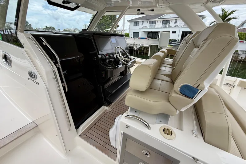Slide: The Image of 2018 Pursuit S 408 Sport boat interior with beige seating and modern dashboard. - 51