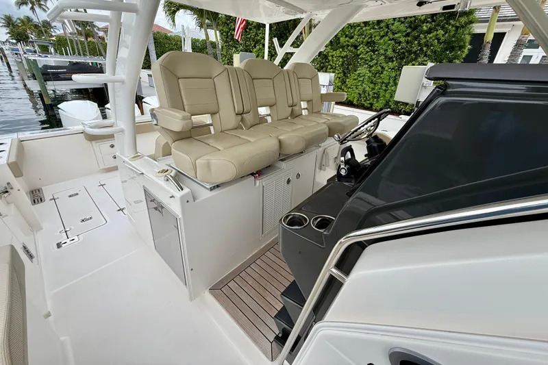 Slide: The Image of 2018 Pursuit S 408 Sport boat interior with beige seating and sleek helm controls. - 55