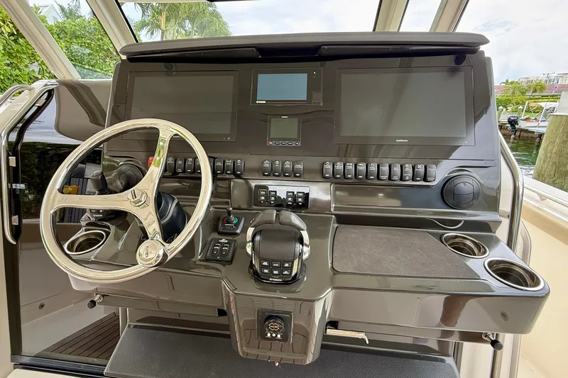 Slide: The Image of Helm of 2018 Pursuit S 408 Sport boat with advanced controls and displays. - 56