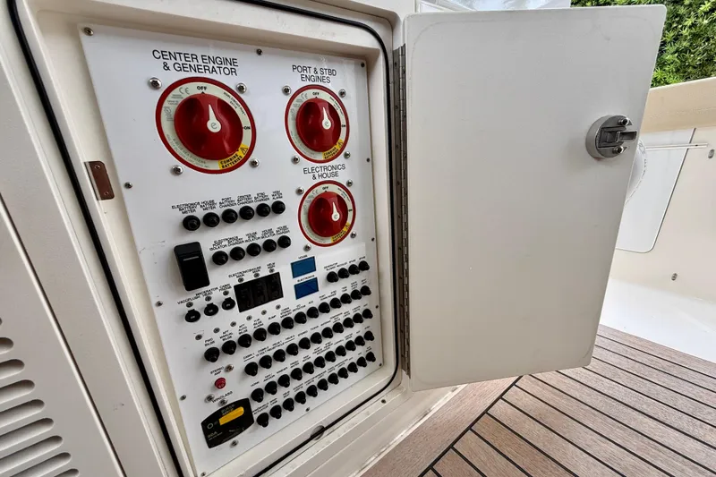 Slide: The Image of Electrical panel on a 2018 Pursuit S 408 Sport boat, featuring engine and generator controls. - 58