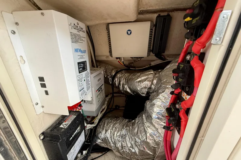 Slide: The Image of Electrical components and wiring inside a 2018 Pursuit S 408 Sport boat. - 59
