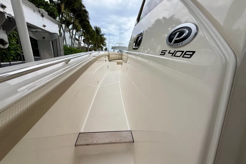 Slide: The Image of 2018 Pursuit S 408 Sport boat side view with logo and sleek design. - 60