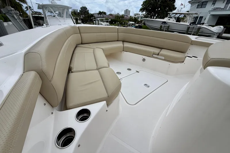 Slide: The Image of Luxurious seating area on a 2018 Pursuit S 408 Sport boat, featuring beige upholstery. - 64