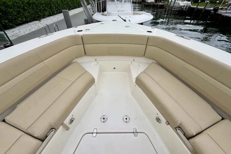 Slide: The Image of Spacious seating area on 2018 Pursuit S 408 Sport boat, docked by the water. - 67