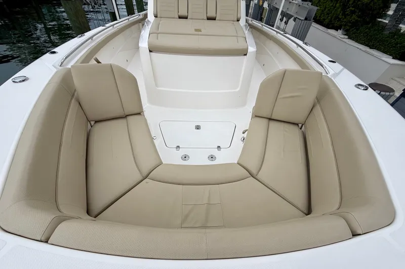 Slide: The Image of 2018 Pursuit S 408 Sport boat with beige cushioned seating in the bow area. - 69