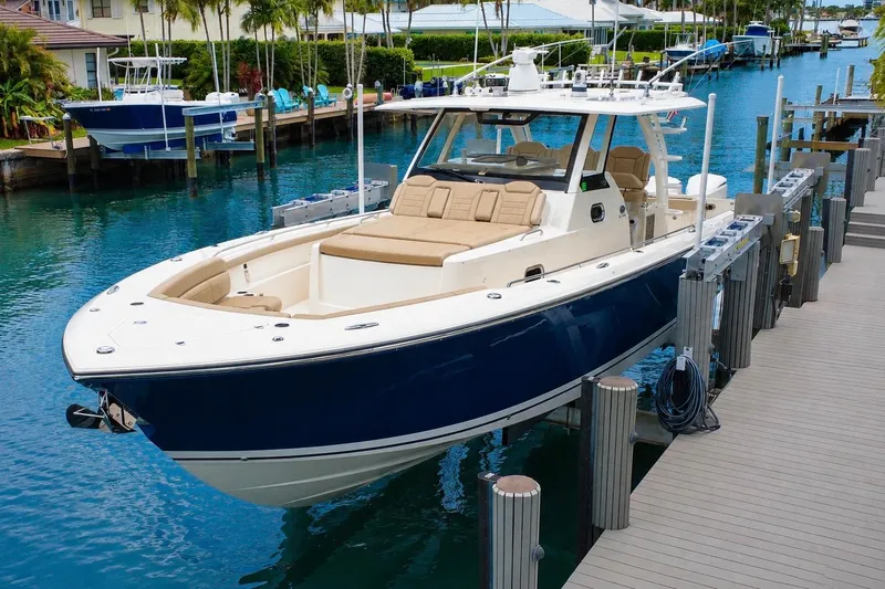 Slide: The Image of 2018 Pursuit S 408 Sport boat docked in a scenic marina setting. - 7