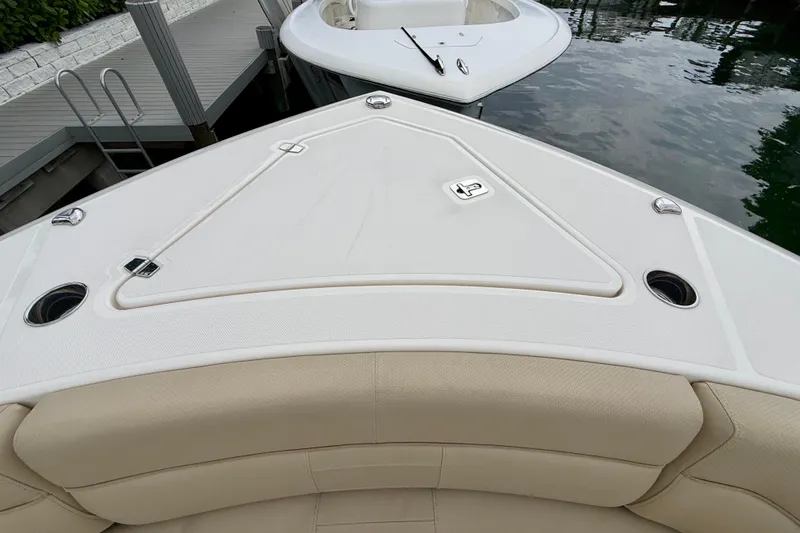 Slide: The Image of 2018 Pursuit S 408 Sport boat bow with seating and storage, docked by the water. - 70