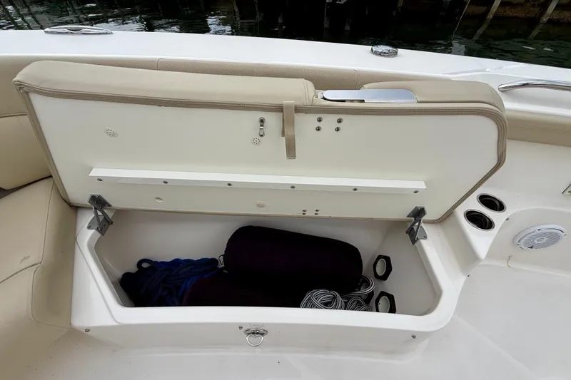 Slide: The Image of Storage compartment on a 2018 Pursuit S 408 Sport boat, open with ropes inside. - 72
