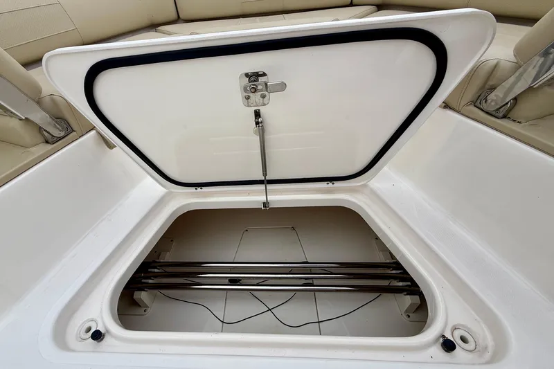 Slide: The Image of Open storage compartment on 2018 Pursuit S 408 Sport boat, showcasing interior space. - 73