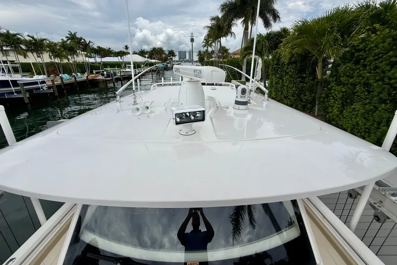 Slide: The Image of 2018 Pursuit S 408 Sport boat docked, featuring sleek design and advanced navigation equipment. - 75